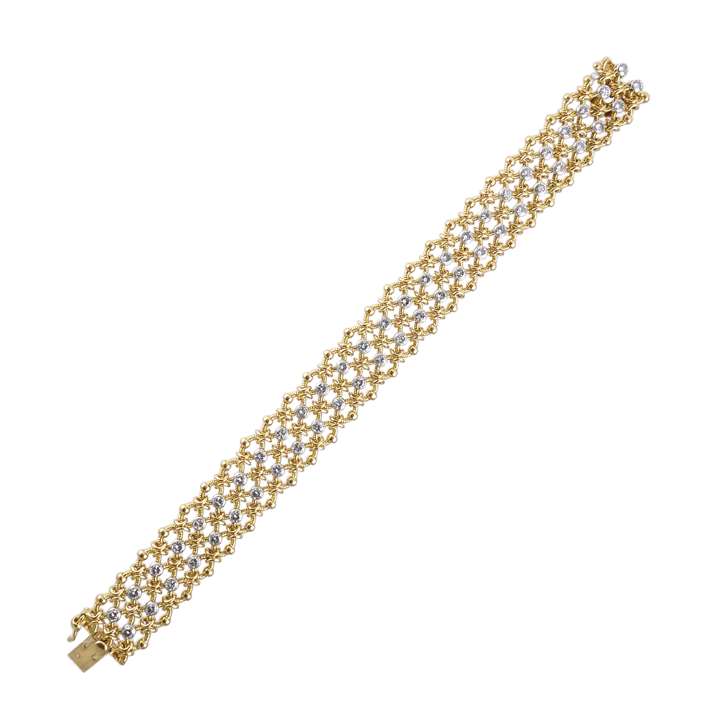 Gold woven chain and diamond strap bracelet by Cartier, the three row oval link mesh spaced by two lines of round brilliant cut diamond collets,